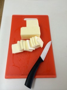 Chopping up blocks of butter for the crust.