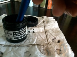 Carefully dipping the pen.