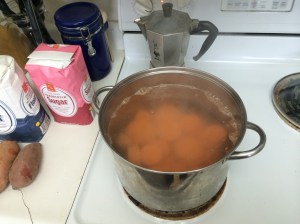 Sliced sweet potatoes boiling.