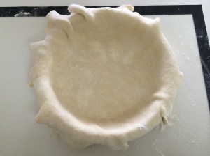 I've carefully coaxed the dough round down into the deep pie dish.